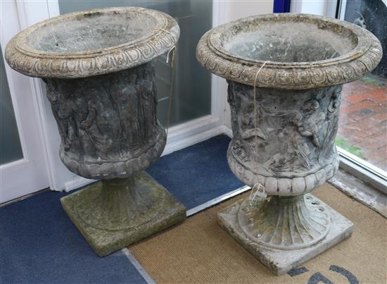 A pair of reconstituted stone campana-shaped urns with classical figures in relief, H 85cm W.63cm